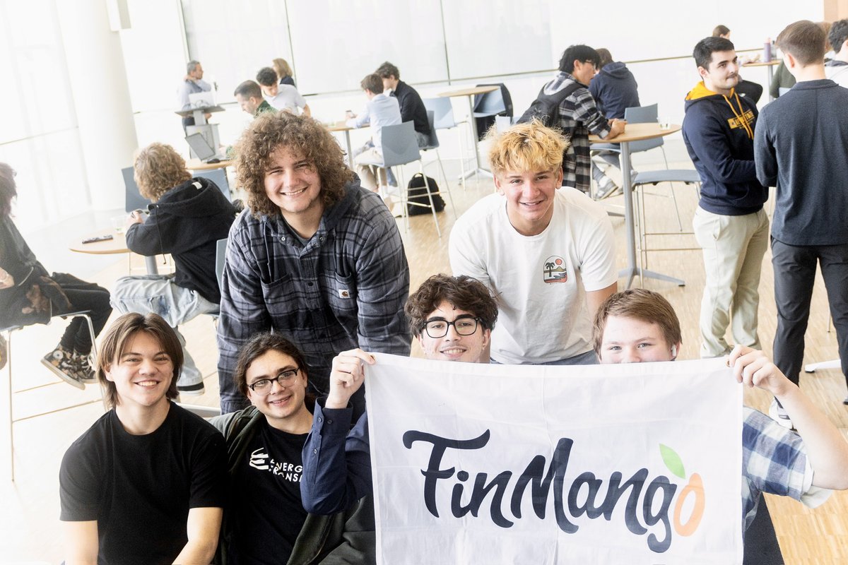 Students holding the FinMango flag at a financial health competition